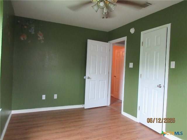 1109 E E Avenue M, Belton, TX 76513 - unfurnished bedroom with wood finished floors and a ceiling fan