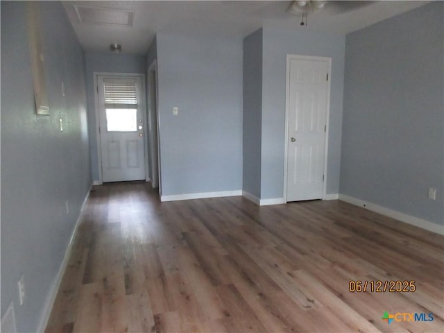 1109 E E Avenue M, Belton, TX 76513 - empty room featuring wood finished floors and attic access