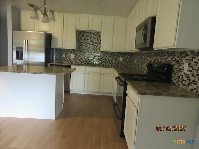 1109 E E Avenue M, Belton, TX 76513 - kitchen with black appliances, dark wood-style floors, backsplash, and white cabinets