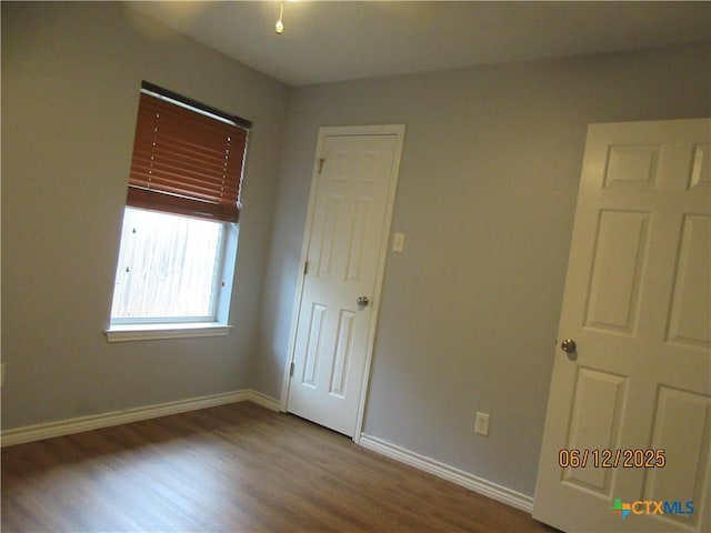 1109 E E Avenue M, Belton, TX 76513 - unfurnished bedroom with wood finished floors and baseboards