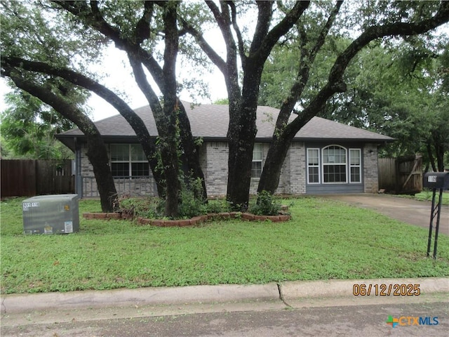 1109 E E Avenue M, Belton, TX 76513 - ranch-style house featuring a shingled roof, stone siding, and brick siding