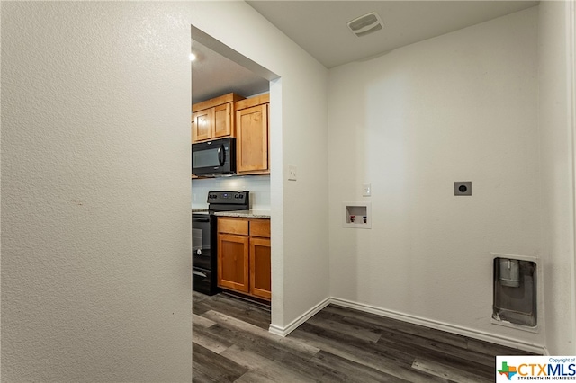 washroom with dark wood-type flooring, washer hookup, and hookup for an electric dryer