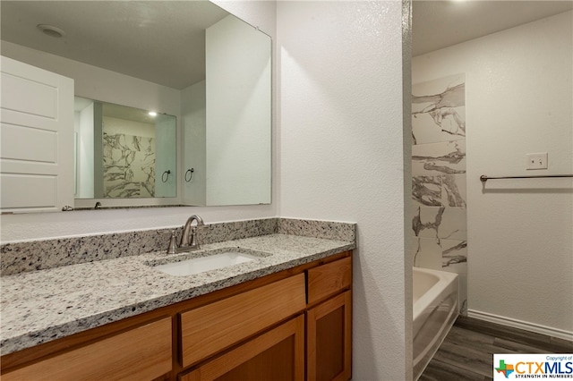 bathroom with hardwood / wood-style floors and vanity