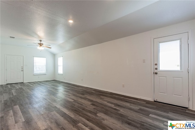 foyer with a textured ceiling, dark hardwood / wood-style floors, ceiling fan, and vaulted ceiling