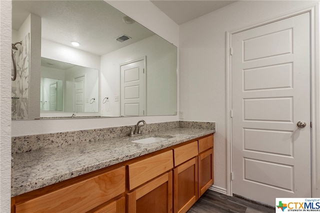 bathroom featuring hardwood / wood-style flooring and vanity