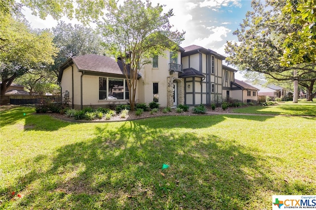 english style home with a front lawn