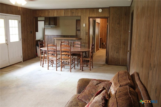 1610 Bexar Ave, Victoria, TX 77901 - carpeted dining room with wooden walls and ceiling fan