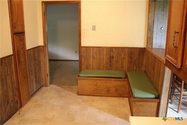 1610 Bexar Ave, Victoria, TX 77901 - unfurnished dining area with a wainscoted wall, wallpapered walls, and wooden walls