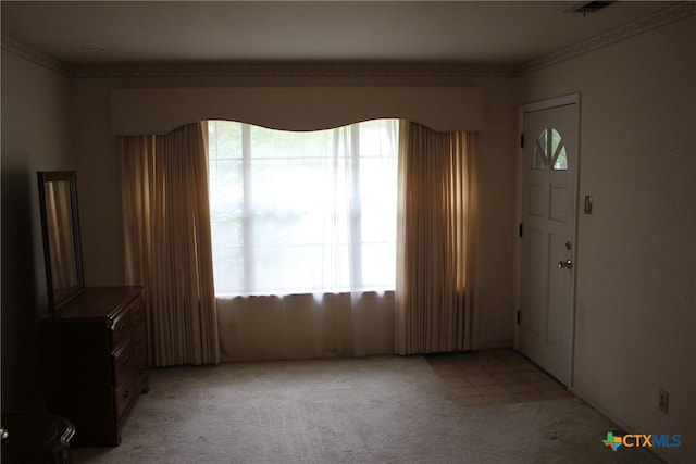 1610 Bexar Ave, Victoria, TX 77901 - entrance foyer featuring light colored carpet and ornamental molding