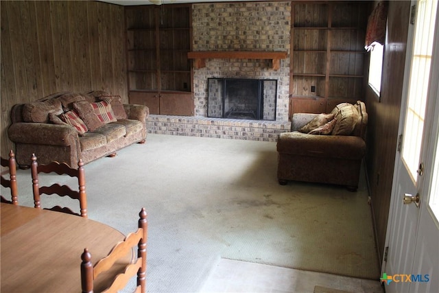 1610 Bexar Ave, Victoria, TX 77901 - carpeted living area featuring wood walls, a fireplace, and built in features