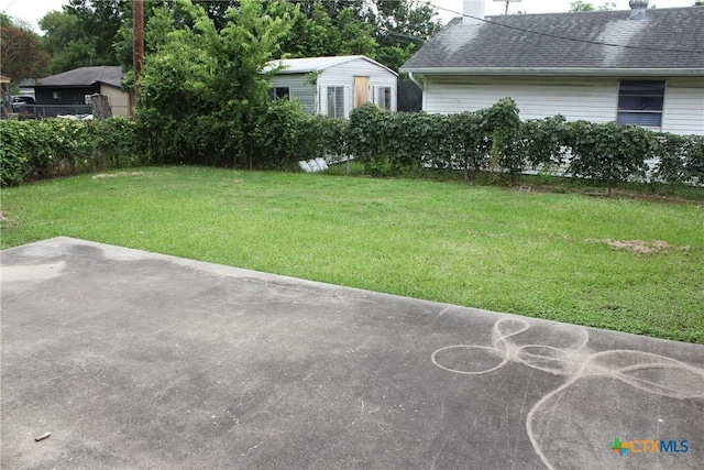 1610 Bexar Ave, Victoria, TX 77901 - view of green lawn featuring a patio area and a shed