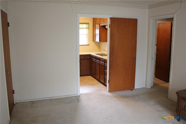 1610 Bexar Ave, Victoria, TX 77901 - kitchen with light countertops, light carpet, and brown cabinetry