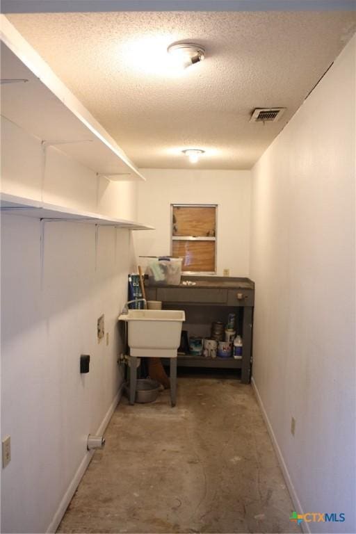 1610 Bexar Ave, Victoria, TX 77901 - washroom featuring baseboards and a textured ceiling