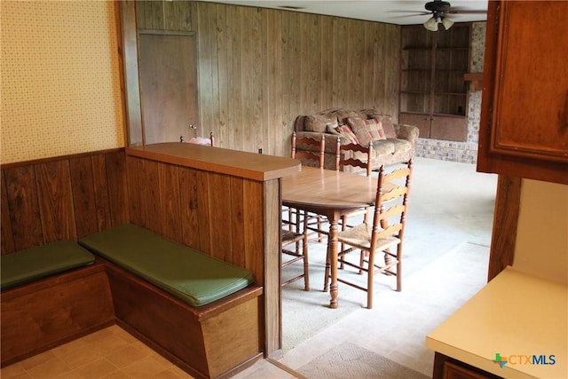 1610 Bexar Ave, Victoria, TX 77901 - dining area with wooden walls, ceiling fan, a wainscoted wall, and wallpapered walls