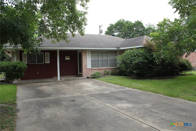 1610 Bexar Ave, Victoria, TX 77901 - ranch-style house featuring driveway, brick siding, and a front lawn