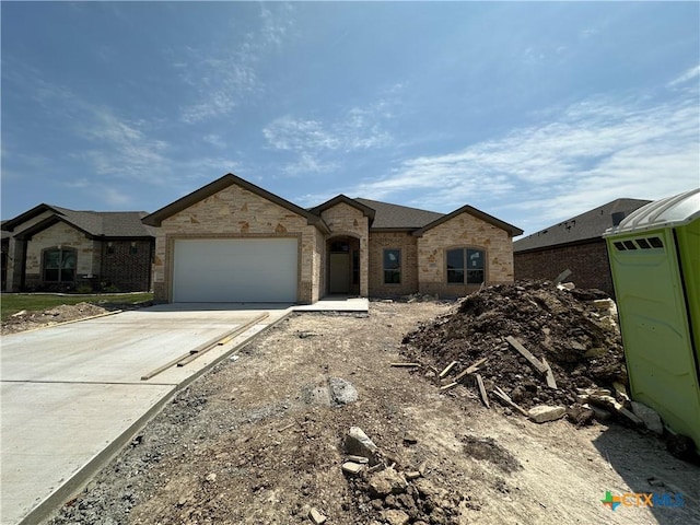 2007 Yarrow Rd, Temple, TX 76502 - french country home with a garage, concrete driveway, and brick siding