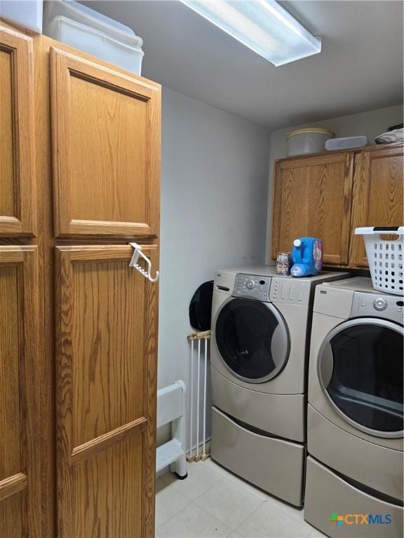 114 Quapaw Dr, Harker Heights, TX 76548 - laundry area featuring cabinet space, washing machine and clothes dryer, and light tile patterned floors