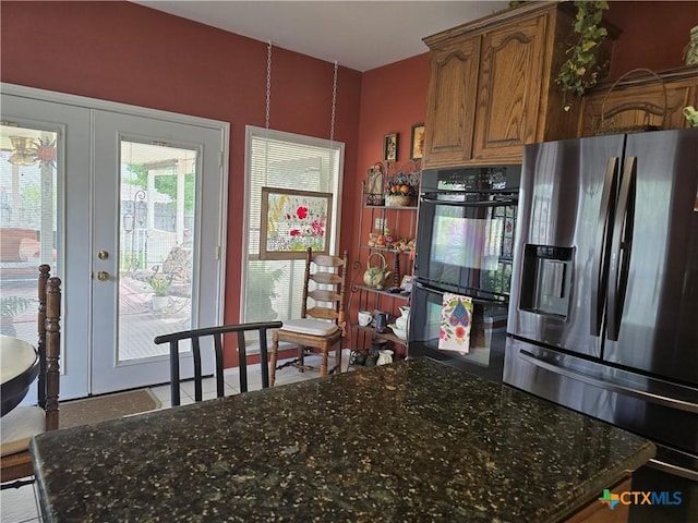 114 Quapaw Dr, Harker Heights, TX 76548 - kitchen with stainless steel refrigerator with ice dispenser, brown cabinets, dark stone counters, and french doors