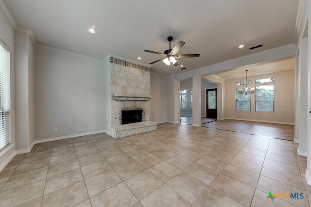 unfurnished living room featuring ceiling fan with notable chandelier, a fireplace, light tile patterned floors, and crown molding