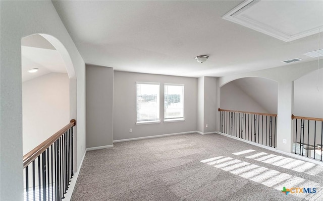 carpeted empty room featuring lofted ceiling and ornamental molding