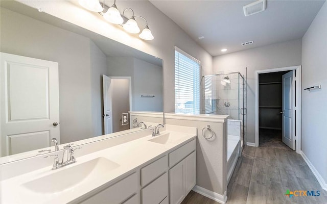 bathroom featuring vanity, hardwood / wood-style flooring, and an enclosed shower