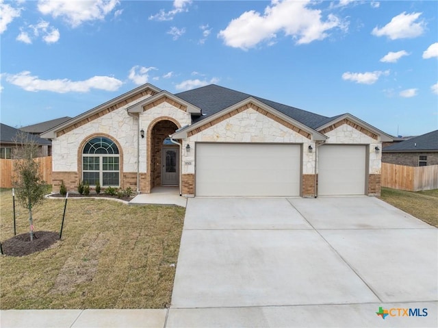 ranch-style home featuring a garage and a front lawn