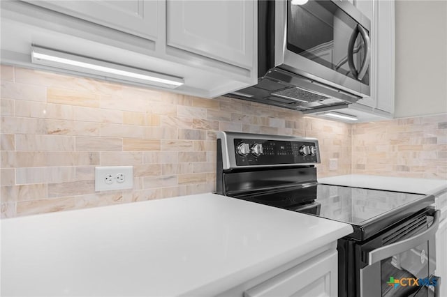 kitchen featuring white cabinetry, appliances with stainless steel finishes, and tasteful backsplash