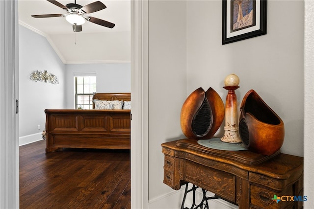 bedroom featuring vaulted ceiling, ceiling fan, dark hardwood / wood-style flooring, and ornamental molding