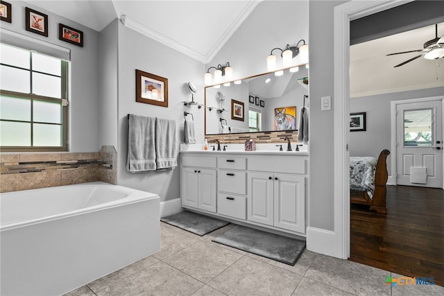 bathroom featuring ornamental molding, lofted ceiling, tile patterned floors, and vanity