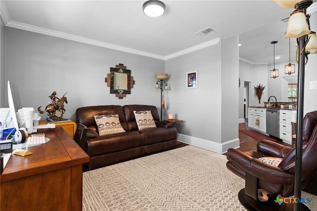 living room featuring sink and crown molding