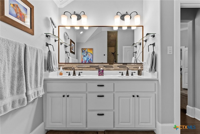 bathroom with decorative backsplash, hardwood / wood-style floors, ornamental molding, vanity, and walk in shower