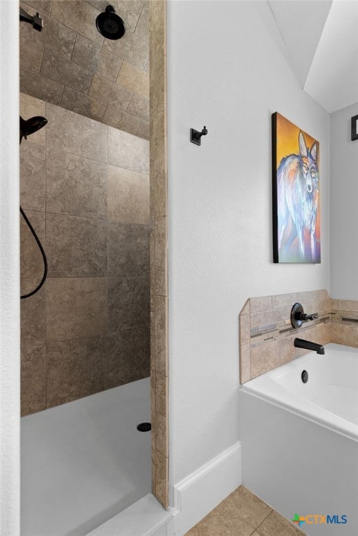 bathroom with tile patterned flooring and independent shower and bath