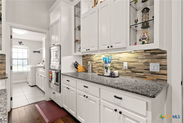 kitchen featuring dark stone countertops, dark hardwood / wood-style flooring, and white cabinets