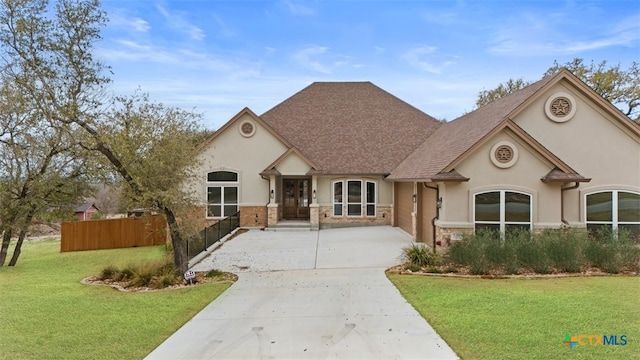 7026 Troyan Ln, Temple, TX 76502 - view of front of property with stucco siding, roof with shingles, concrete driveway, and stone siding