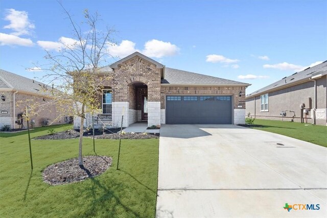 213 Bellows St, Georgetown, TX 78633 - french country style house with brick siding, a garage, driveway, and a front lawn