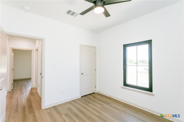 spare room featuring light hardwood / wood-style flooring and ceiling fan