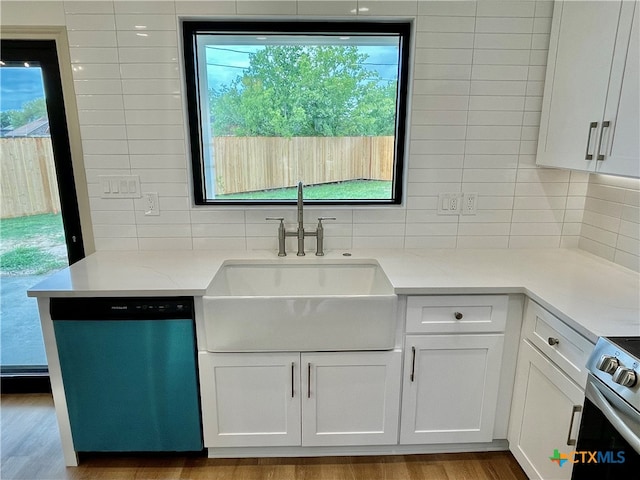 kitchen with sink, backsplash, white cabinets, light stone counters, and stainless steel appliances