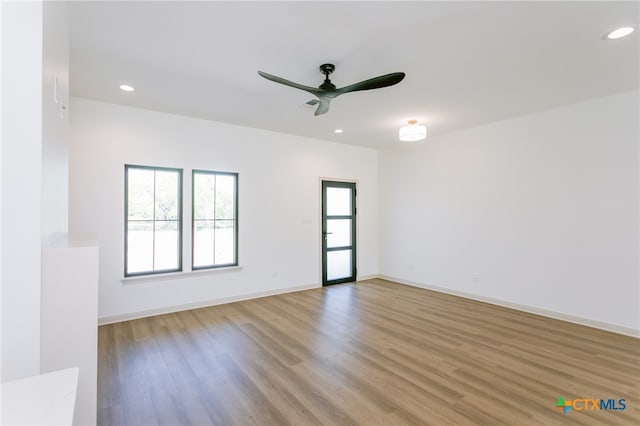 spare room featuring light hardwood / wood-style flooring and ceiling fan