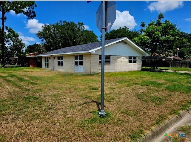 view of side of property with a lawn