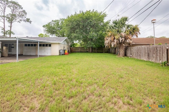 view of yard featuring a garage and a fenced backyard