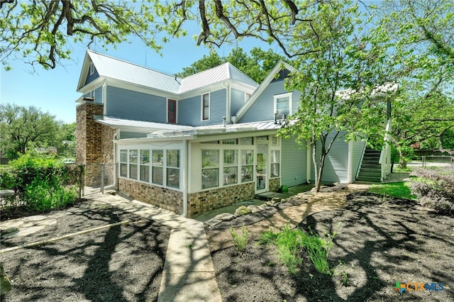 rear view of house with a sunroom