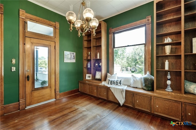 interior space featuring ornamental molding, wood-type flooring, and a notable chandelier