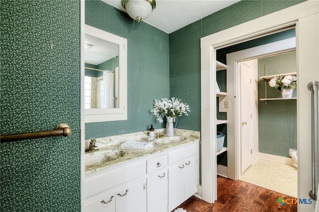 bathroom featuring a shower with shower curtain, hardwood / wood-style flooring, and vanity