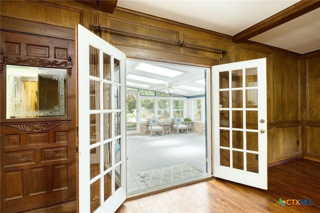 doorway with wood walls, french doors, and hardwood / wood-style flooring