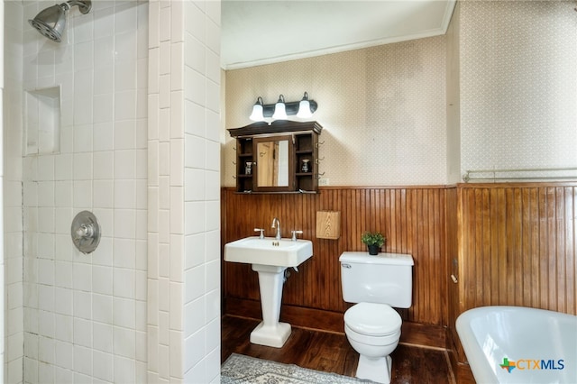 bathroom featuring wood-type flooring, crown molding, shower with separate bathtub, wood walls, and toilet