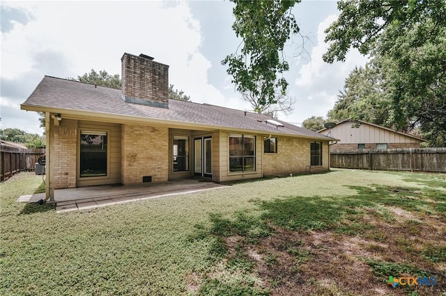 505 Bramble Bush Ln, Victoria, TX 77904 - rear view of house featuring a fenced backyard, brick siding, a chimney, a patio area, and a shingled roof