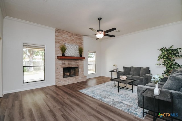 505 Bramble Bush Ln, Victoria, TX 77904 - living room with healthy amount of natural light, crown molding, a ceiling fan, wood finished floors, and a fireplace