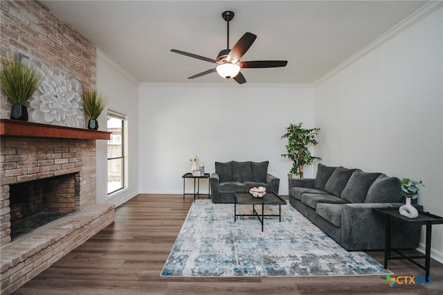 505 Bramble Bush Ln, Victoria, TX 77904 - living room featuring a ceiling fan, crown molding, a brick fireplace, and wood finished floors