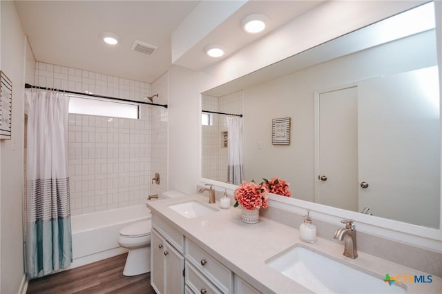 505 Bramble Bush Ln, Victoria, TX 77904 - bathroom with double vanity, shower / bath combo, wood finished floors, and recessed lighting
