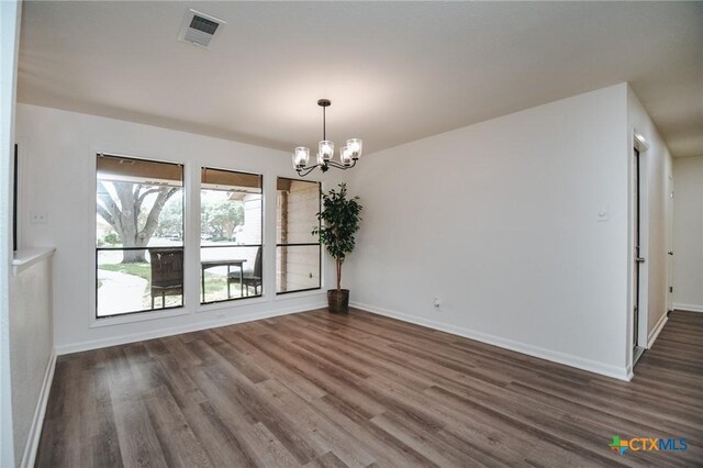 505 Bramble Bush Ln, Victoria, TX 77904 - spare room featuring a chandelier and dark wood-style flooring